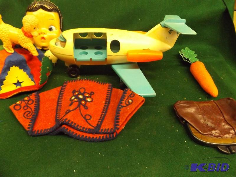 lot 89 image: plastic airplane, coin purse, doll head...