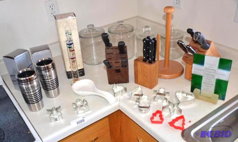 lot 182 image: Four glass canisters, cookies cutters, knives...