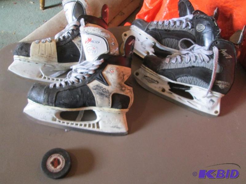 2 Pairs of hockey skates. One is size 9D the ...