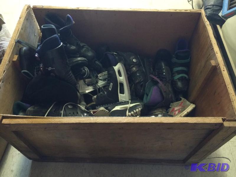 wood crate of ice skates and roller skates