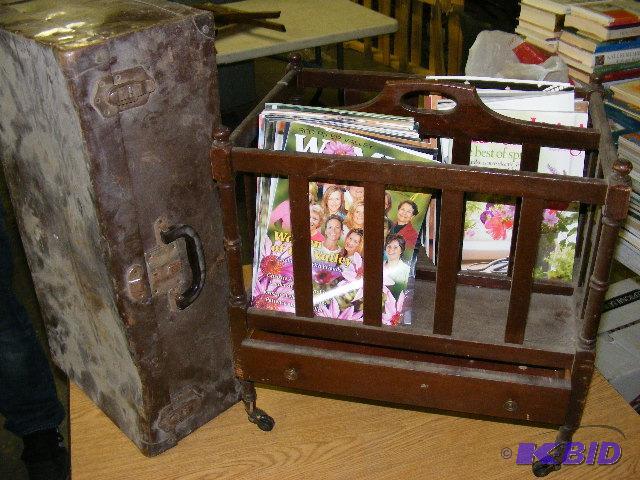 magazine rack with magazines, suitcase