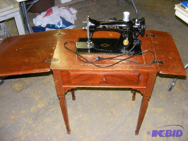 Antique Singer sewing machine in cabinet
