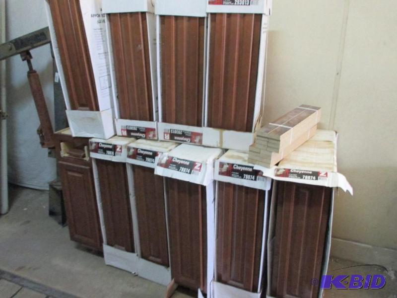 lot 140 image: stack of new cabinets...