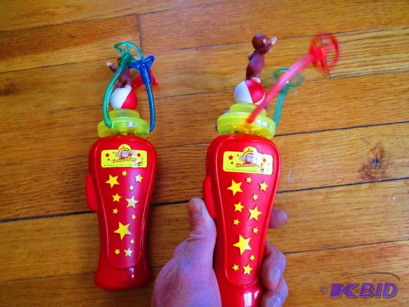 lot 210 image: 2 Curious George spinning toys, the 3 colored...