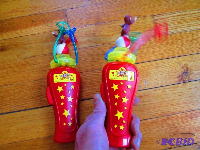 lot 211 image: 2 Curious George spinning toys, the 3 colored...