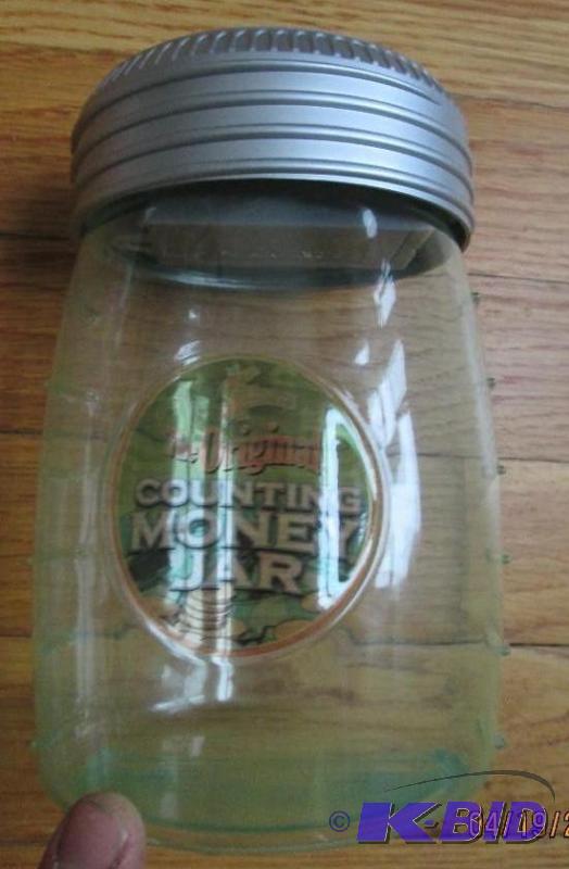 lot 80 image: Counting money jar coin bank...