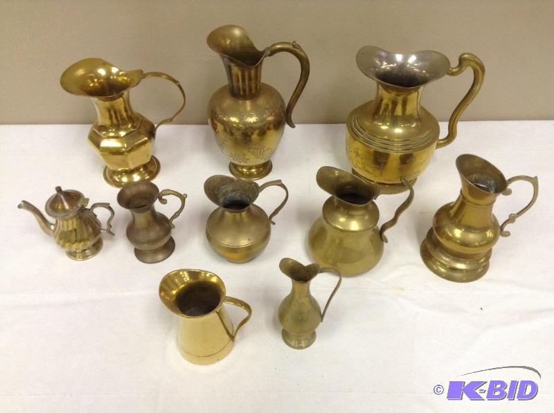 lot 99 image: Grouping of Brass Pitchers