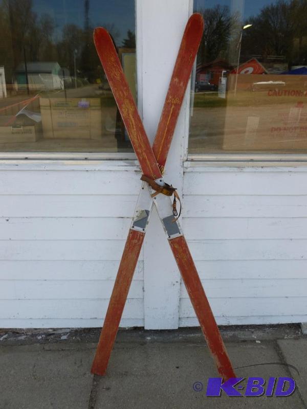 lot 12 image: A pair of vintage wooden skies, measures 60&q...
