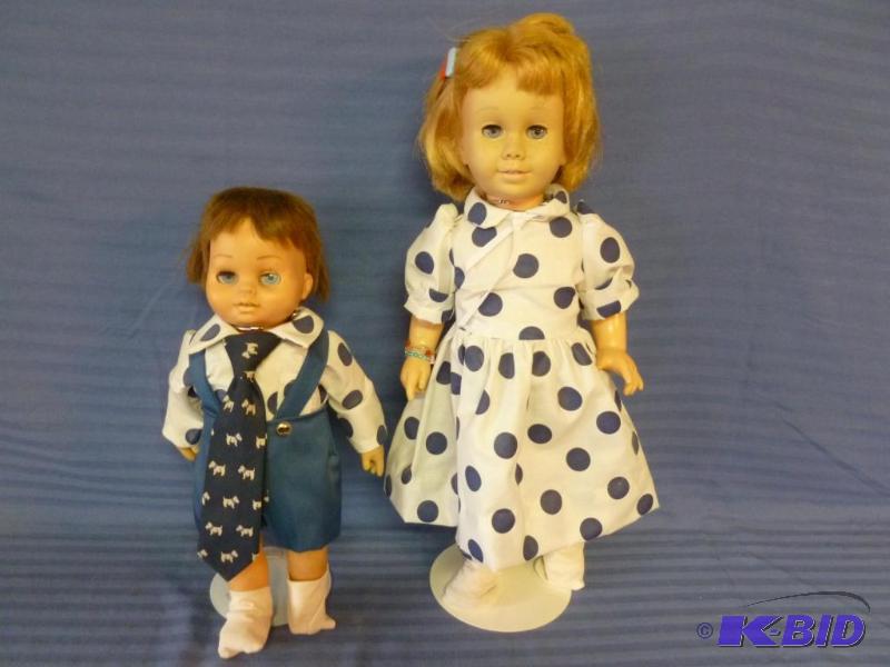 lot 14 image: Lot of two collectible dolls with stands that...