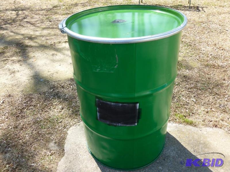lot 68 image: Large 55 gallon steel barrel, comes with a to...