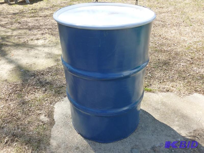 lot 69 image: Large 55 gallon steel barrel, comes with a to...