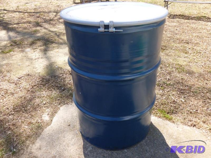 lot 70 image: Large 55 gallon steel barrel, comes with a to...