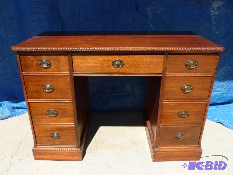 lot 5 image: Vintage Eight Drawer Wooden Desk that measure...
