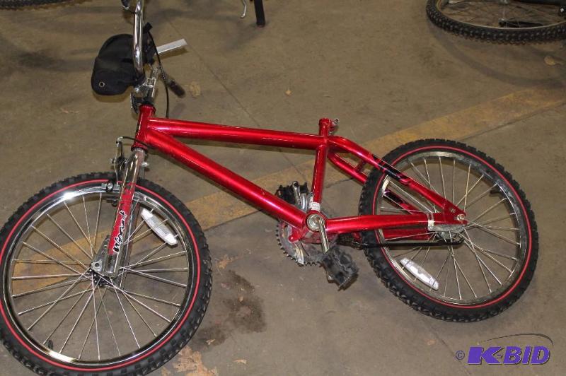 lot 496 image: Next Bike 16 Rims Red Water Bottle Holder Attached To Handle Bars.