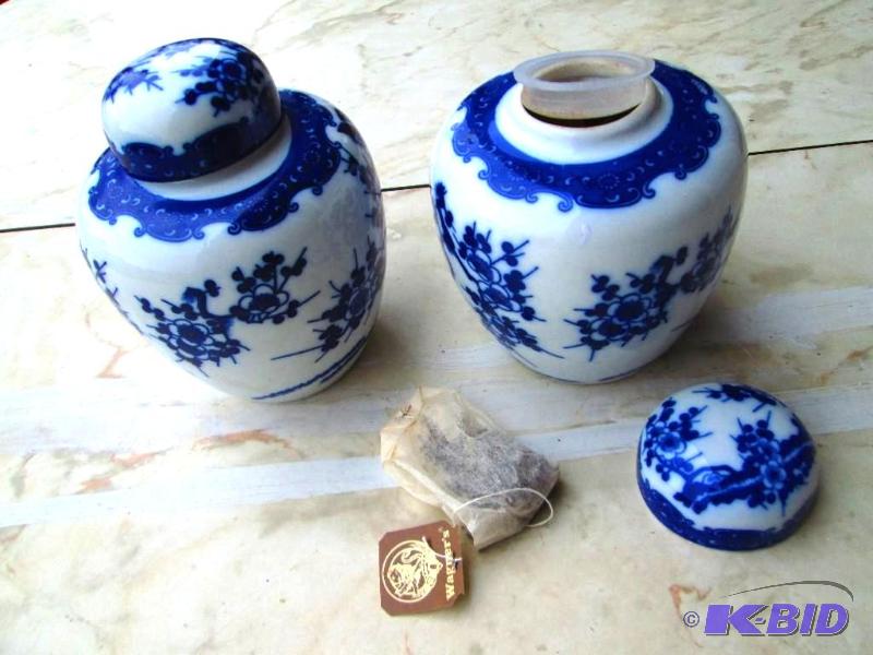 lot 140 image: 2 small urns, one filled with tea bags...