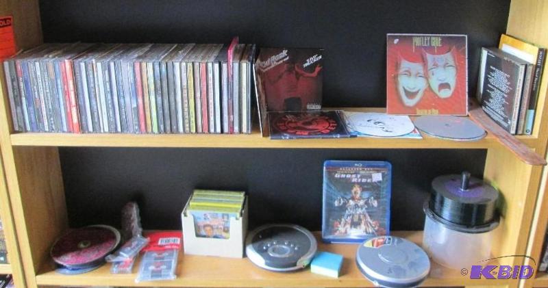 lot 165 image: Assorted CDs and Elvis tapes. The display she...