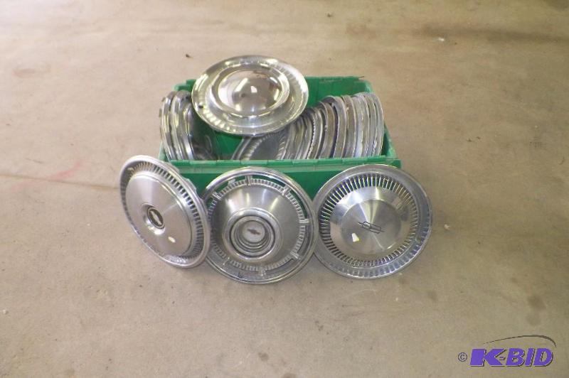 lot 19 image: Tote full of Hub Caps Chevy olds Cutlass 3 sets of 4 - 4 misc.  16 total