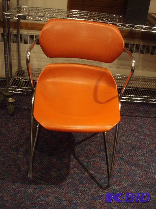 lot 13 image: Orange And Chrome Action Stacker Chair....