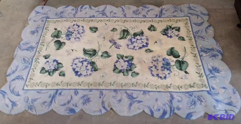lot 36 image: Large Floral Blue Decorative Edged Rug.  Could use a good cleaning.  Vintage or older Rug.  Still nice. 70 x 47