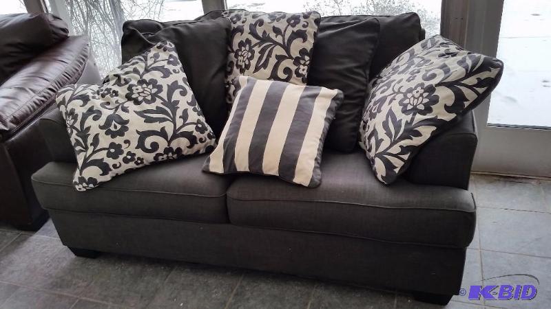 lot 4 image: Ashley Gray Fabric Love Seat and Decorative Pillows.  Gently Used Very Clean