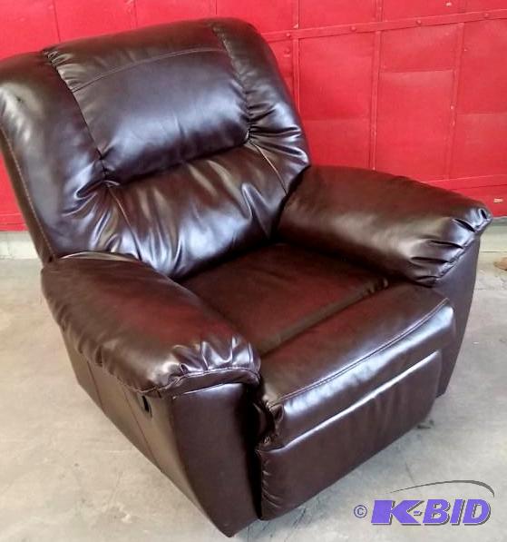 lot 5 image: Ashley Bonded Leather Rocker Recliner.  Was a Store Display. Has a few nicks in the leather see  Pics.