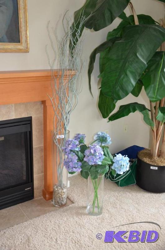 lot 31 image: Two large glass vases with artificial flowers...