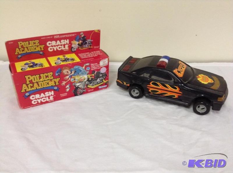 lot 64 image: Police Academy Crash Cycle and Battery Operated Car