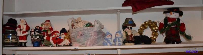 Lot of Christmas items including Santas, can...