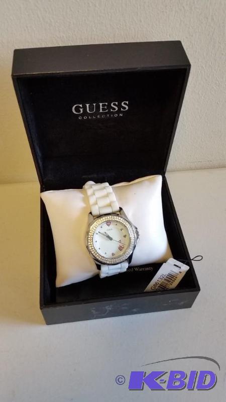 lot 13 image: Ladies Guess Watch. White Band, Clear and Pink Crystals. Appears New in Box. See Pics