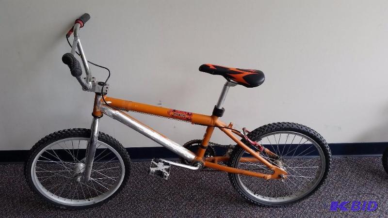 lot 34 image: Orange 20 Wheel Lush Rush Dirt Bike. Could use a good tune up. See Pics