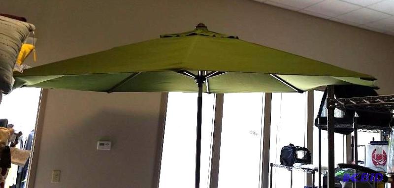 lot 40 image: Patio Umbrella Dark Green.  Needs a pin to keep umbrella up.  Can be fixed.