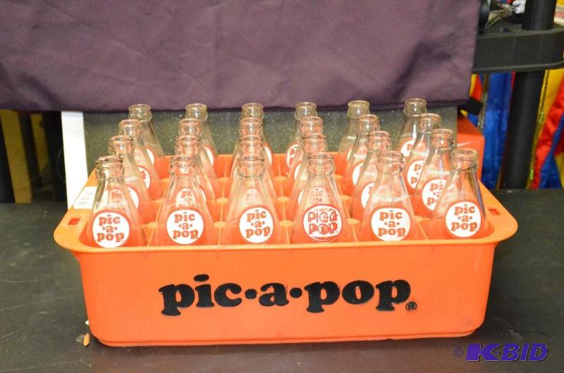 lot 15 image: Vintage Pic-a-pop Glass Bottles - 24 (in oran...
