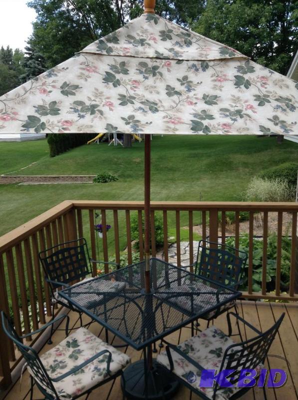 lot 142 image: Green Metal Patio Table with Four Chairs with Pads and Umbrella