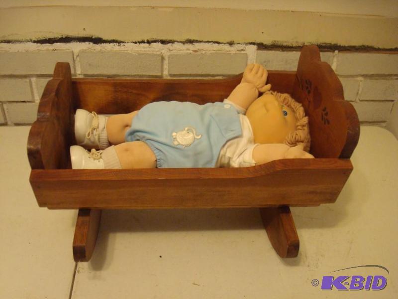 lot 122 image: Cabbage Patch Doll And Wood Cradle. ...