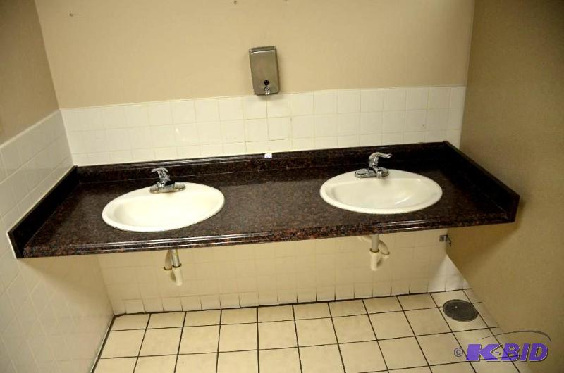 lot 327 image: 2 sinks, counter, mirror, and hand soap dispe...