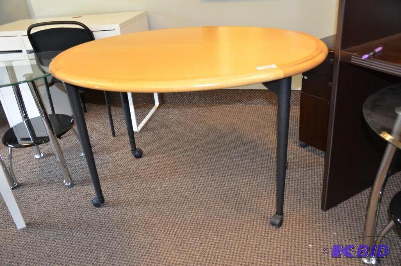 lot 105 image: Oval wood table on wheels. 30&quotx36&quot4...