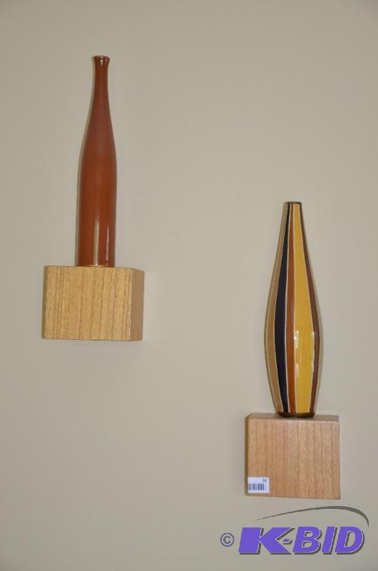 Two pieces of modern wall art each with a vas...