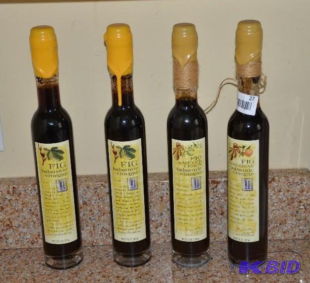 Four unused balsamic vinegar bottles with con...