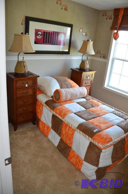 Single bed with decorative pillows and bedspr...