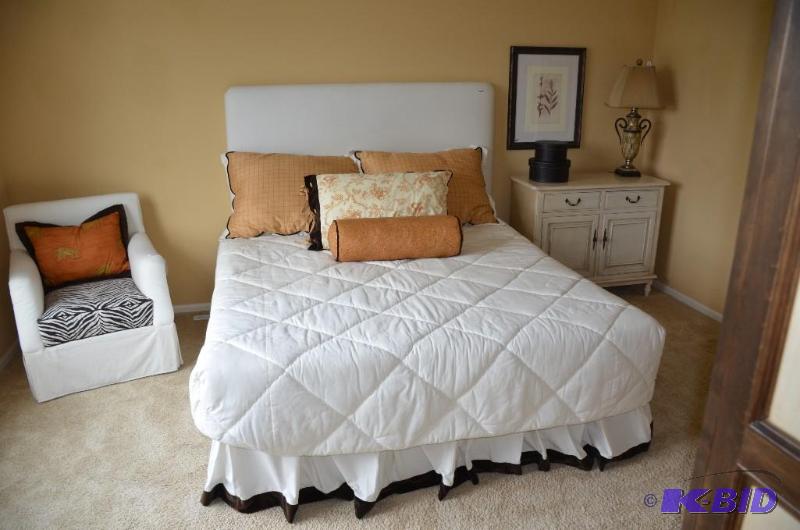 King size bed with headboard, decorative cove...