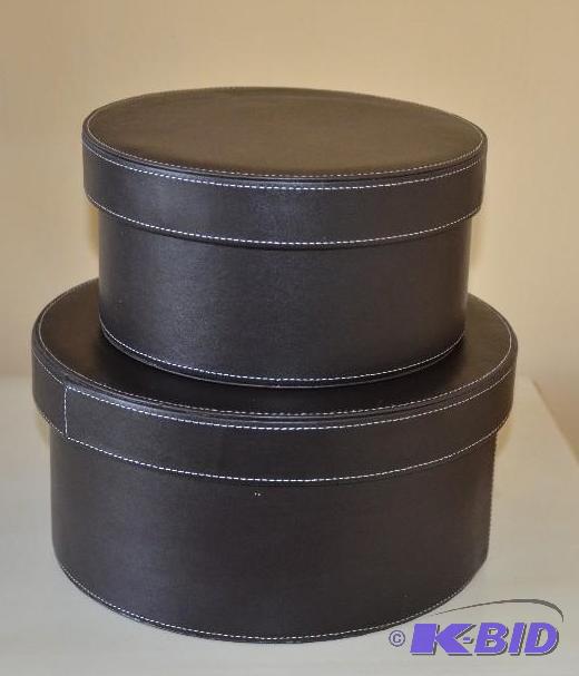 Two round (possible) leather decorative conta...