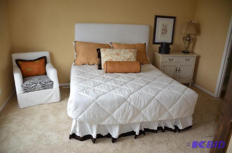 White chair with zebra pattern cushion and ac...