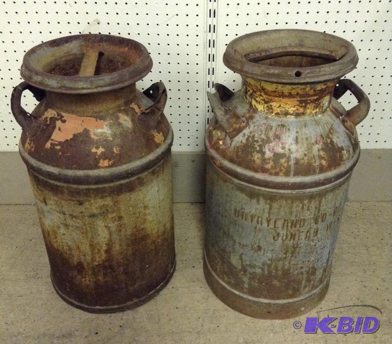 lot 42 image: Two Metal Milk Cans - Dairyland Co-op