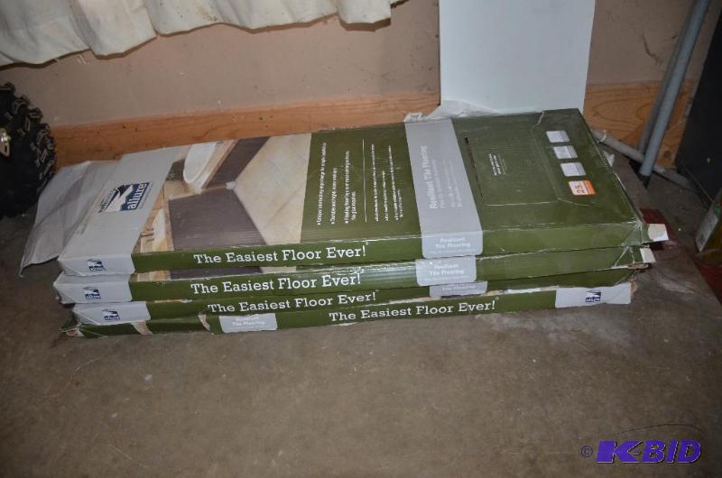 lot 210 image: Boxes of new flooring in green boxes, self st...