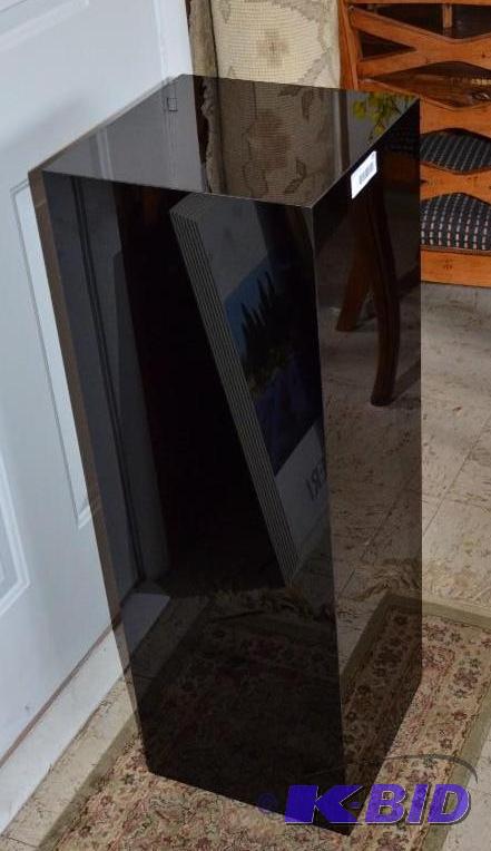 lot 49 image: Black plant stand 12x12x36 tall. It looks lik...