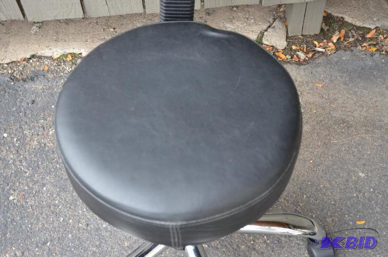 lot 14 image: 1 chair with back on wheels and adjustable he...