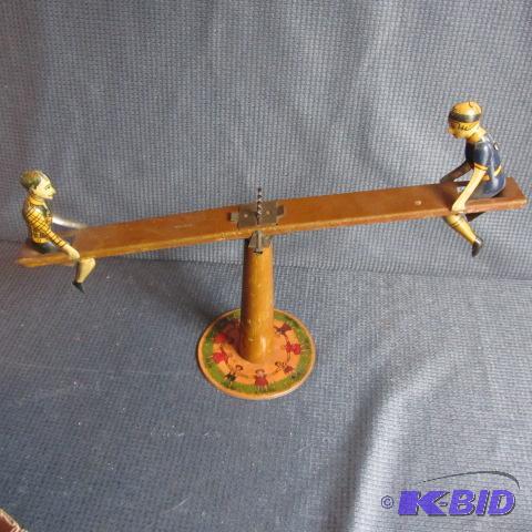 lot 254 image: Antique Tin Teeter Totter