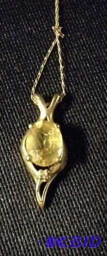 lot 42 image: Lovely 10k Pendant with Yellowish Oval Stone
