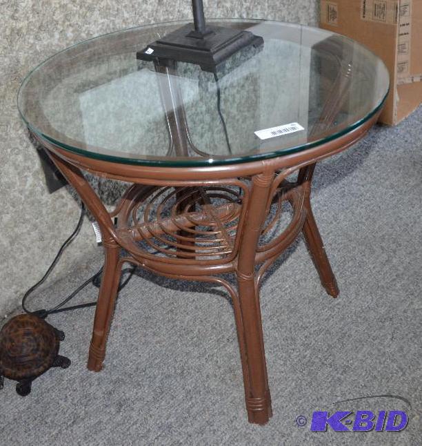 lot 40 image: Glass top table round with wicker legs 24x24...