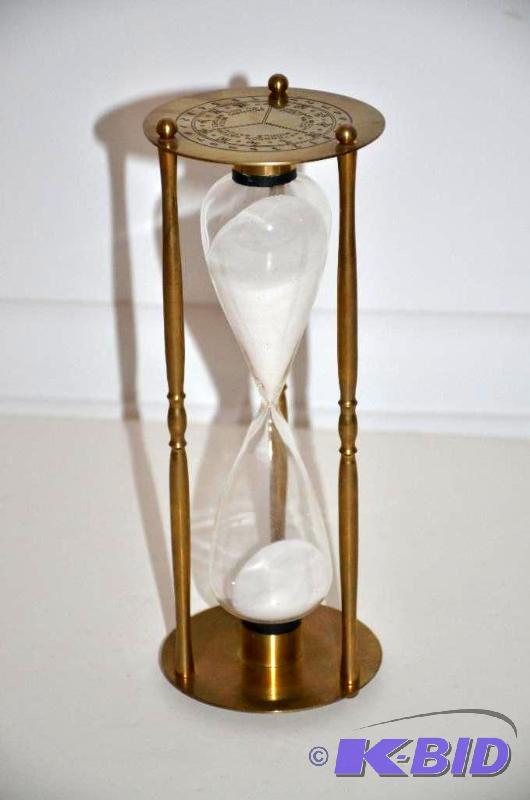 lot 100 image: Brass hour glass 9" tall...